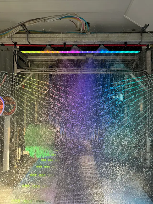 Inside the Mickey's tunnel: the rainbow LED light bar, spray arches and a green wash brush over the grated floor