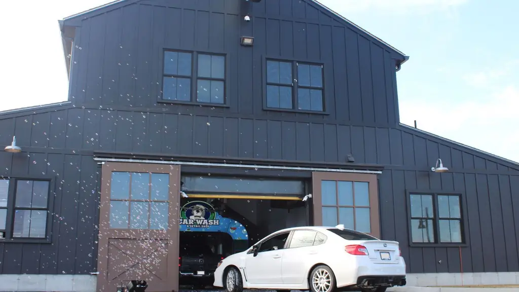 A Subaru in front of the Mickey's barn with bubbles in the air and the dog arch glowing inside the tunnel door
